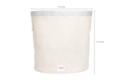 3 Sprouts canvas storage bin in nursery for blankets and plush toys.