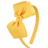7Rainbows cute yellow gold bow headband on toddler keeps hair away from the face