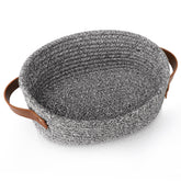 ABenkle small woven basket shown on a shelf for towels and small items.