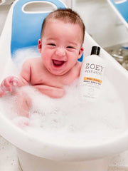 Child enjoying tear free bath with Zoey Naturals citrus bubble bath