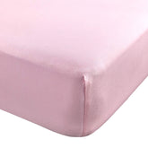 Abstract Cotton Crib Sheet in solid pink offers a soft touch for baby sleep.