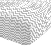 Abstract Cotton Crib Sheets gray zigzag folded for a soft, cozy nursery look.