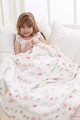 aden + anais Boutique Dream Blanket draped over a crib for versatile nursery use.