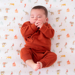 aden + anais Essentials Classic Crib Sheet shows a calm baby sleeping, breathable open weave