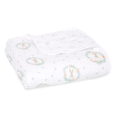 aden + anaïs Essentials Dream Blanket laid flat, breathable four-layer muslin for newborn comfort.