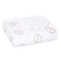aden + anaïs Essentials Dream Blanket laid flat, breathable four-layer muslin for newborn comfort.