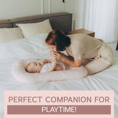 Aila + Aiden pink lounger in tummy-time setup with breathable surface for baby activity.