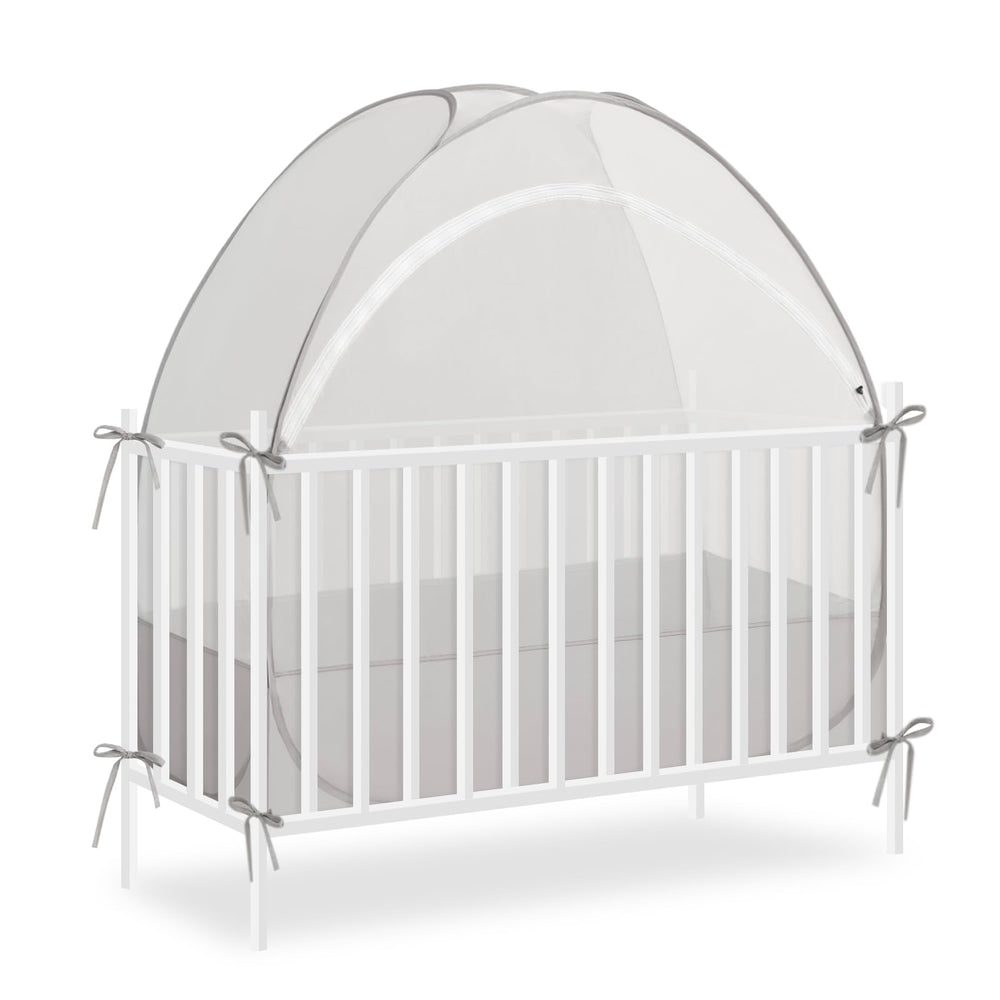 Akiky crib tent over a crib, fully opened for quick setup.
