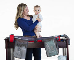Anna & Eve diaper bag opened to show accessible pockets for diapers and creams.