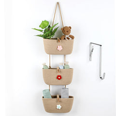 Apausvcm over-the-door three-tier hanging basket storing toys and towels.