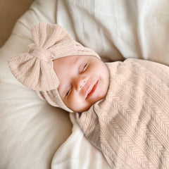 AQOKKA adjustable headband on baby, comfortable styling.