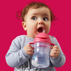 b.box Sippy Cup with easy grip handles and markings supports independent drinking.