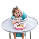 Baby bib Food Catcher Bib and Tray Set on a high chair keeps mess off the floor.