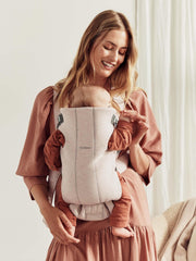 Front-facing-in position on Baby Björn Carrier Mini for cozy closeness