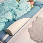 Banbaloo bed bumper shown between mattress and sheet for secure sleep space