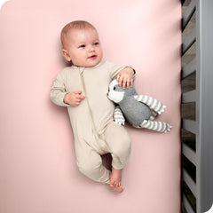 Bare Home white fitted crib sheet demonstrates snug elastic fit for secure sleep.