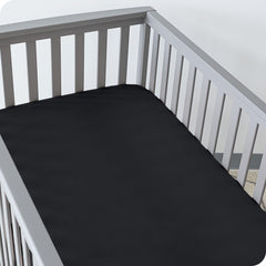 Elastic-edged Bare Home crib sheet demonstrates secure grip during use.