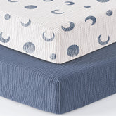 Bearmoss muslin mini crib sheet with blue crescent on Pack-N-Play mattress for cozy naps