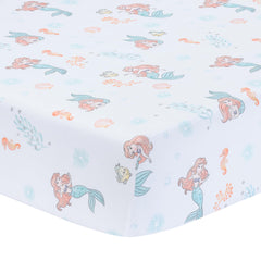 Bedtime Originals Ariel watercolor coral seafoam crib sheet with gentle ocean hues for nap time.