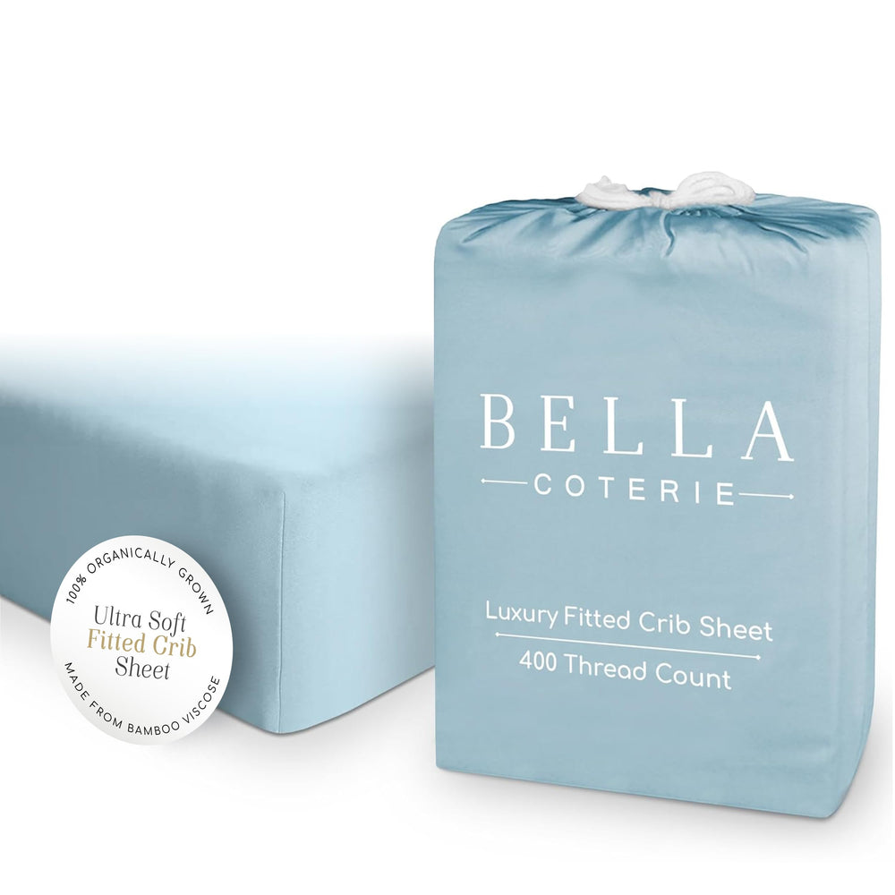 Bella Coterie coastal blue crib sheet folded, displaying silky bamboo viscose feel for sensitive skin.