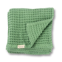 Bella Tunno waffle baby blanket in sea foam, neatly folded for cozy nursery décor.