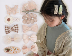 BIANHUAN 10-piece baby hair clips set with soft cotton fabric for gentle styling.