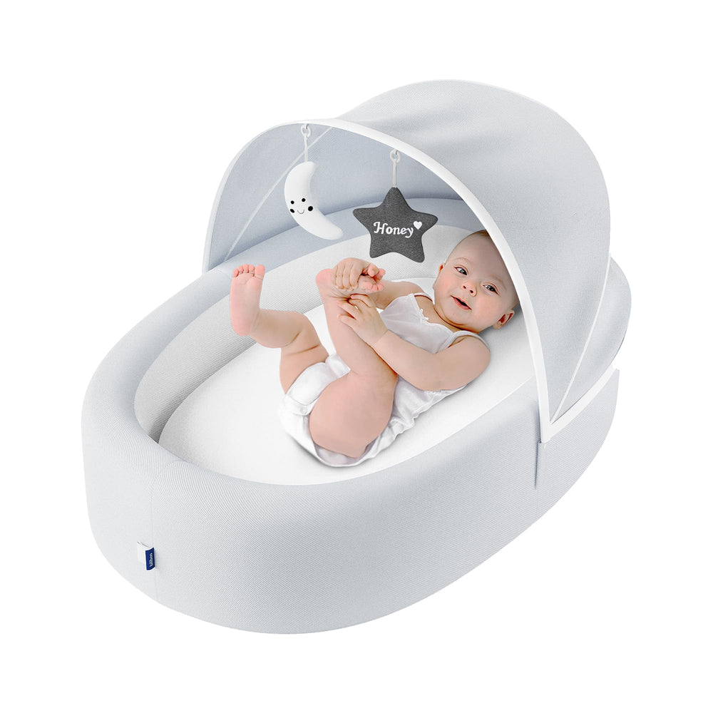 Biliboo premium portable baby lounger with cream cover for cozy newborn support.