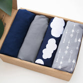 Biloban 4-pack navy cloud playard sheets on mattress for smooth nightly sleep.