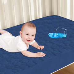 Biloban crib mattress protector waterproof cover shown on a crib mattress for spill protection and easy cleanup
