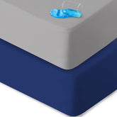 Biloban crib sheets waterproof 2-pack showing snug elastic fit, protects mattress from spills.