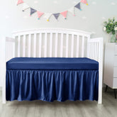Biloban navy four-sides pleated crib skirt covers standard cribs and hides under-bed storage.