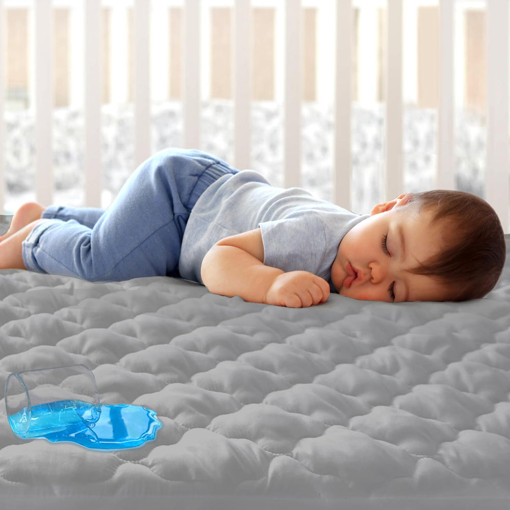 Biloban mini crib protector showing waterproof layer for spill protection.