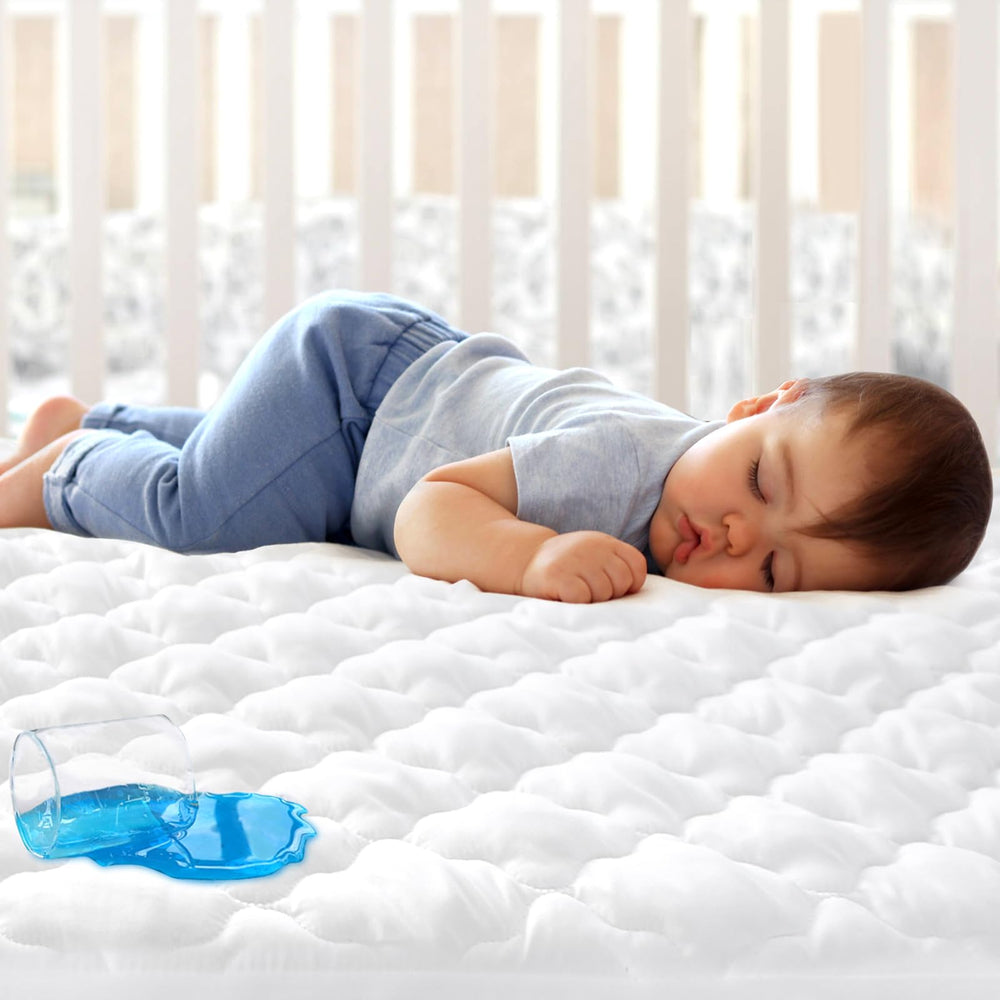 Biloban waterproof mini crib protector fitted to a 38x24 mattress, guards against leaks