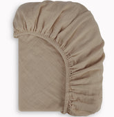 BIOWEAVES organic muslin crib sheet in soft, breathable weave for baby comfort.