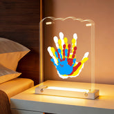 Bixinyo family handprint kit with light on a glowing wooden base for a cozy nursery display