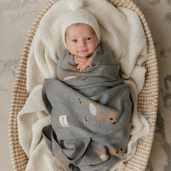 Bleu La La deer grey swaddle around baby in nursery with cozy fabric