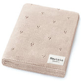 Bleu La La Pointelle Swaddle Blanket in oatmeal offers breathable, gentle comfort for delicate newborn skin.