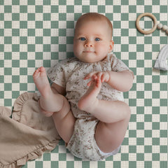 Blissful Diary elastic-fit crib sheet keeps sheets secure during playtime.