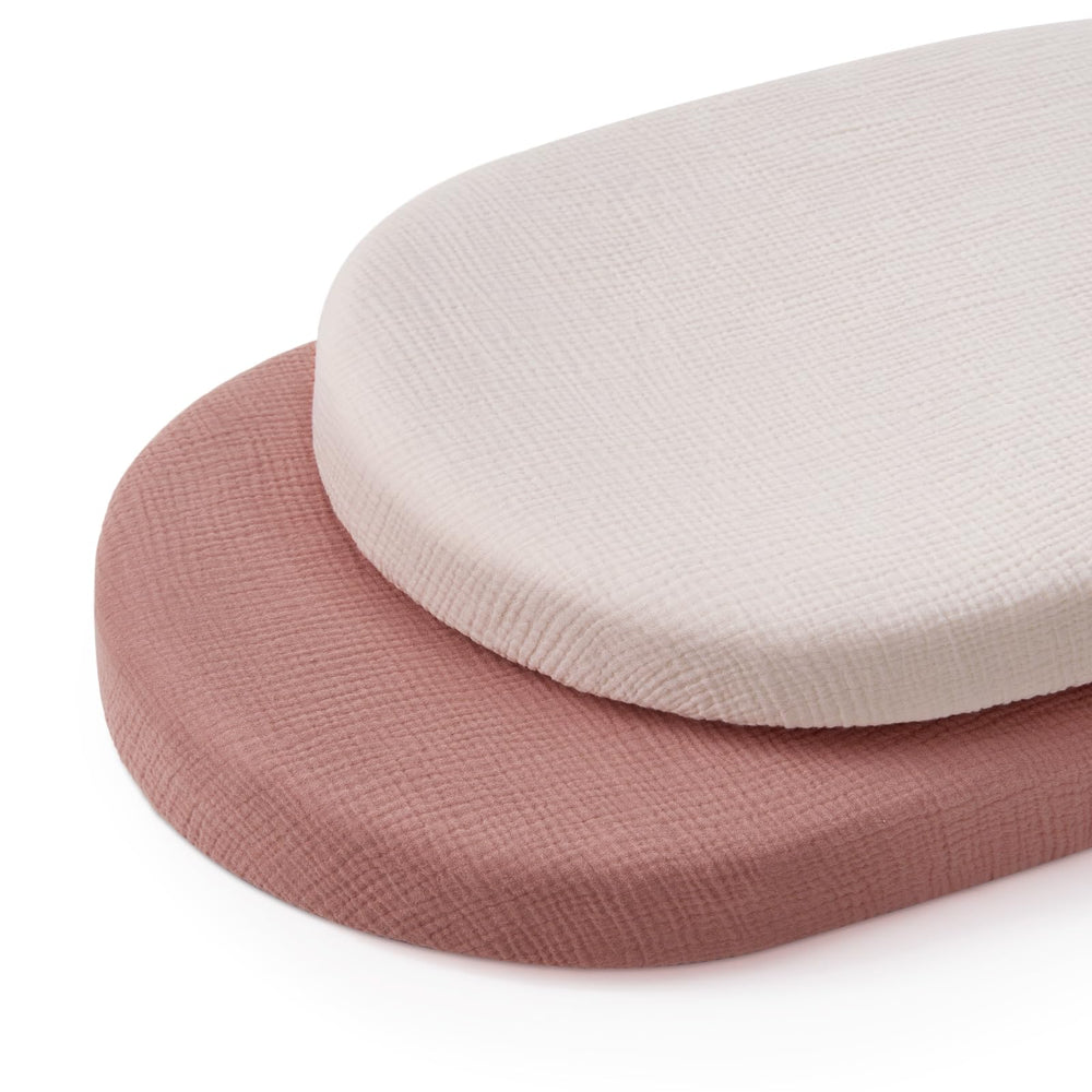 Blissful Diary muslin bassinet sheet in dusty pink, breathable texture for delicate skin.