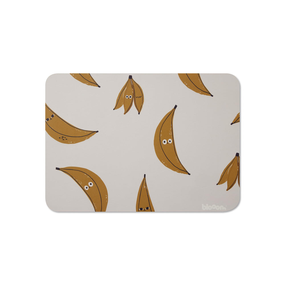 Blooom banana placemat for mealtime with spill-resistant surface.