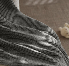 Boll & Branch care-friendly blanket image highlights machine washing for busy families.