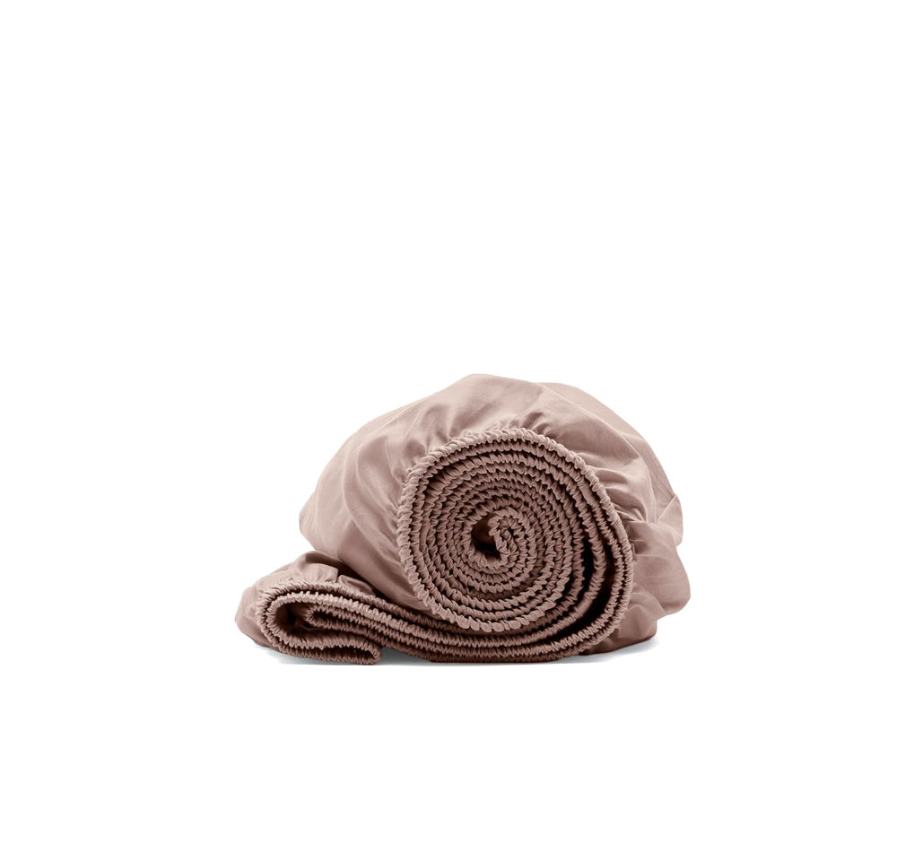 Boll & Branch Signature crib sheet in dusty rose with ultra-soft weave for baby comfort.