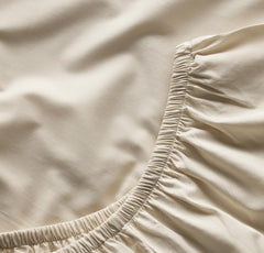 Boll and Branch Signature crib sheet secure fit showing top-stitched elastic around mattress.