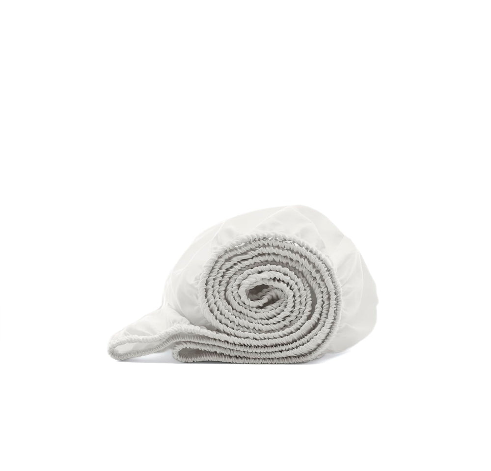 Boll and Branch signature hemmed fitted crib sheet secures standard crib.