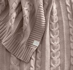 Close-up of the cable knit texture, showcasing organic cotton softness.