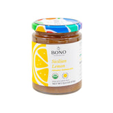 Bono Sicilian Organic Marmalade lemon jar on a rustic table showcases fresh fruit flavor.