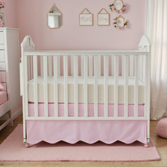 Brandream pink gingham nursery skirt complements gender-neutral decor.