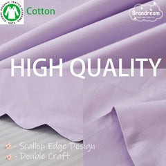 Brandream scallop edge crib skirt on a standard crib demonstrates four-sided fit.