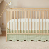 Brandream scallop-edge crib skirt in green gingham adds elegant nursery detail.