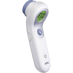 Braun NTF3000 no-touch thermometer taking a quick forehead reading in a dim room